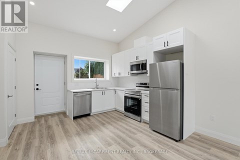 A kitchen with white cabinets and stainless steel appliances.