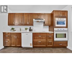 A kitchen with wooden cabinets and white appliances.