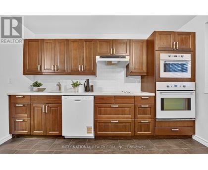A kitchen with wooden cabinets and white appliances.