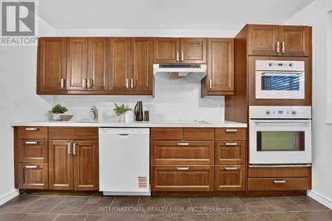 A kitchen with wooden cabinets and white appliances.