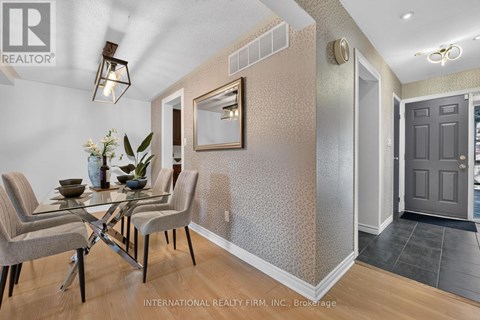 A dining room with a glass table and chairs.