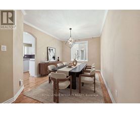 A dining room with a table set for six.