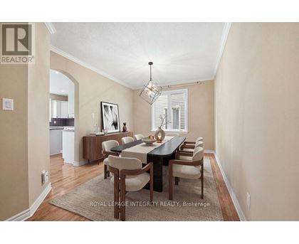 A dining room with a table set for six.