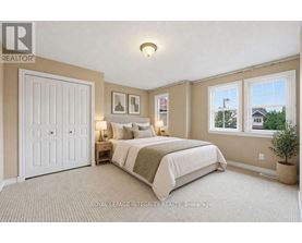 A bedroom with a large bed and a window overlooking a street.