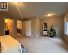 A bedroom with a bed, a dresser, and a window.