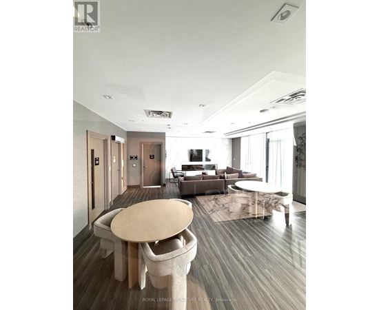 A modern living room with a large table and chairs.