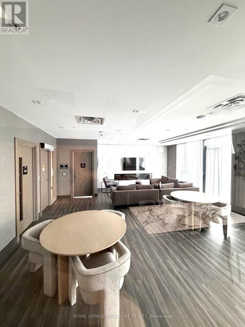 A modern living room with a large table and chairs.