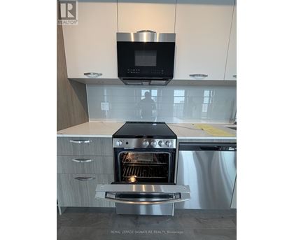 A modern kitchen with a stainless steel oven and microwave above it.