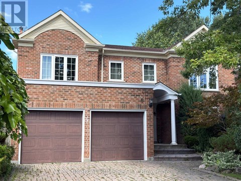 A brick house with two garage doors.