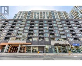 A tall building with many windows and a sign that says RE/MAX Escarpment Realty Inc.