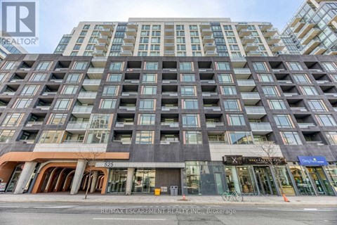 A tall building with many windows and a sign that says RE/MAX Escarpment Realty Inc.