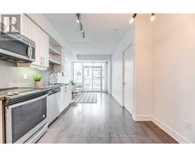 A modern kitchen with white cabinets and a stainless steel oven.