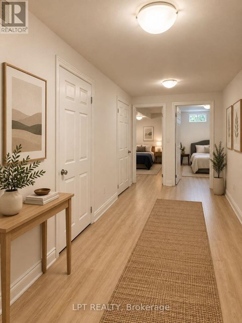 A hallway with a brown rug and a wooden table with a plant on it.