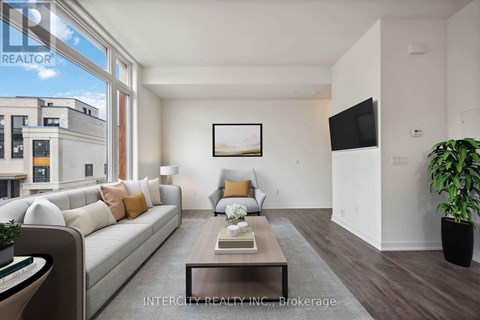 A living room with a couch, coffee table, and a flat screen TV.