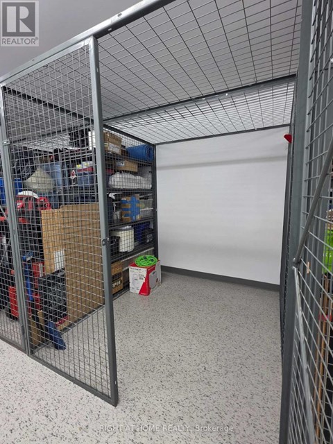 A room with a white wall and a wire fence.