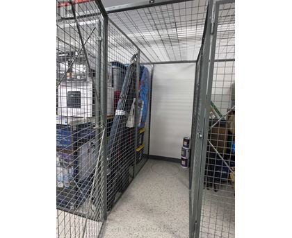 A storage room with a whiteboard and a white door.