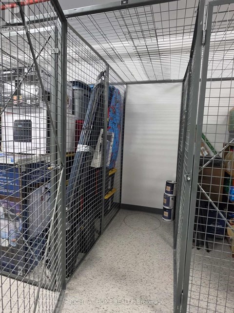 A storage room with a whiteboard and a white door.