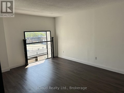 A room with a sliding glass door leading to a parking lot.
