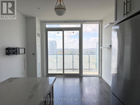 A kitchen with a marble counter top and a view of the city.