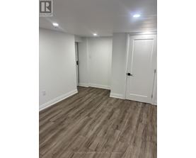 A room with white walls and wood flooring.