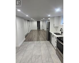 A kitchen with white cabinets and a black stove top oven.