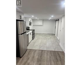A kitchen with a refrigerator, stove, and oven.
