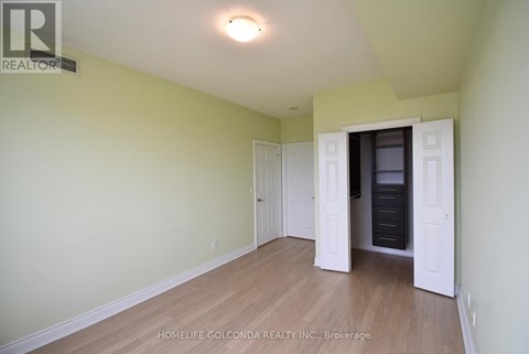 A room with a white door and a light on the ceiling.