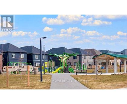 A playground with a green slide and a sign that says "Gateway Park".