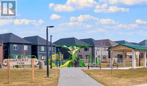 A playground with a green slide and a sign that says "Gateway Park".