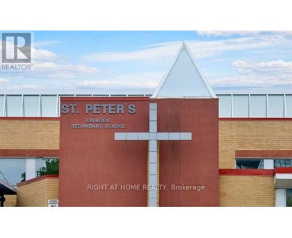 A church with a cross on it and a sign that says St. Peter's Catholic Secondary School.