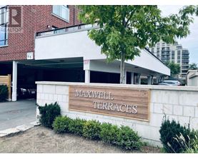A sign that says Maxwell Terraces in front of a building.