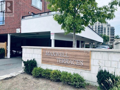 A sign that says Maxwell Terraces in front of a building.