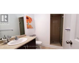 A bathroom with a sink, toilet and shower.