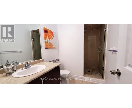A bathroom with a sink, toilet and shower.
