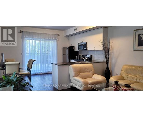 A living room with a white sofa and a white chair.