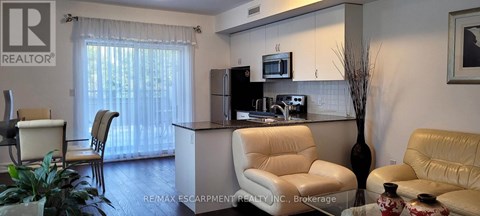 A living room with a white sofa and a white chair.