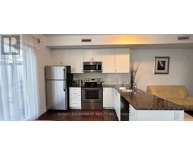 A kitchen with granite countertops and white cabinets.