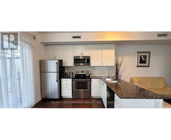 A kitchen with granite countertops and white cabinets.