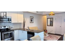 A kitchen with a stove top oven and a sink.
