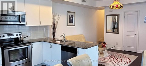 A kitchen with a stove top oven and a sink.
