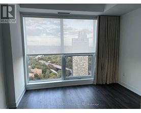 A room with a large window overlooking a cityscape.