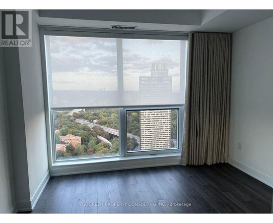 A room with a large window overlooking a cityscape.