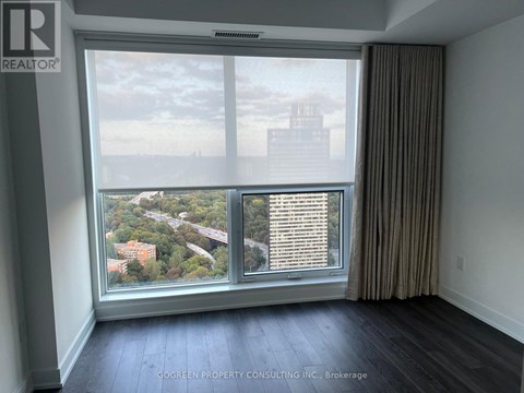 A room with a large window overlooking a cityscape.