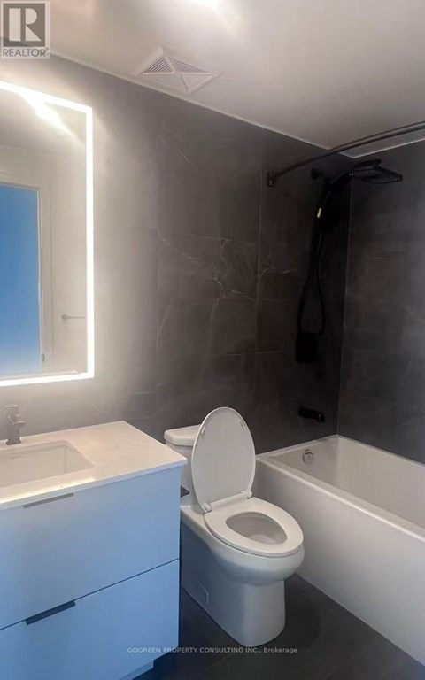 A modern bathroom with a white toilet and a white sink.