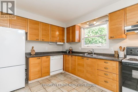A kitchen with wooden cabinets and a white fridge.