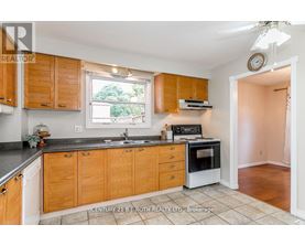 A kitchen with wooden cabinets and a black countertop.