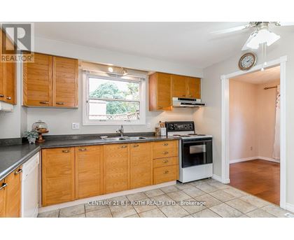 A kitchen with wooden cabinets and a black countertop.