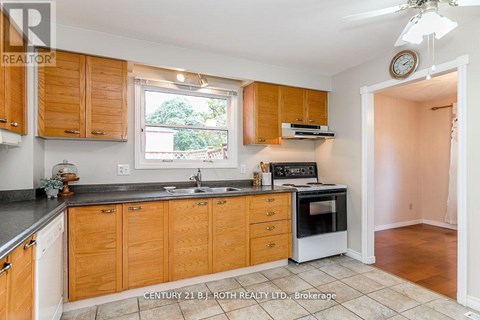 A kitchen with wooden cabinets and a black countertop.