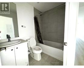 A bathroom with a toilet, sink, and shower.
