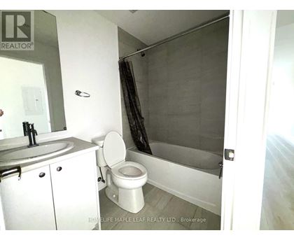 A bathroom with a toilet, sink, and shower.